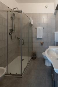a bathroom with a shower and a toilet and a sink at Hotel Giulietta e Romeo in Casal Palocco