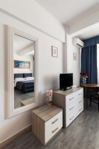 a bedroom with a large mirror and a bed at Hotel Giulietta e Romeo in Casal Palocco