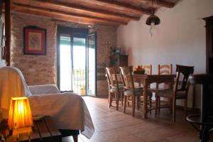 a living room with a table and chairs and a dining room at LA CASA DE LA PARRA in Ulldecona +10 photos