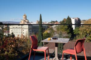un tavolo e sedie su un balcone con vista di Apart-In Georgia a Tbilisi City