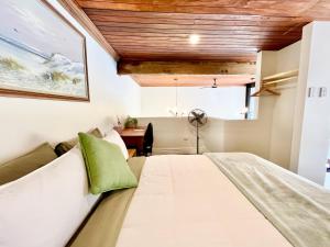 a bedroom with a large bed and a desk at Opoho Heritage Guest Suite in Dunedin