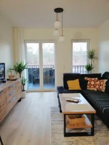 a living room with a couch and a coffee table at Apartament Chodzież blisko jeziora in Chodzież