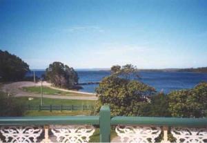 a view of the ocean from a balcony at Ormiston House in Strahan