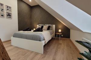 a bedroom with a white bed and a staircase at Le Perchoir - EasyEscale in Nogent-sur-Seine