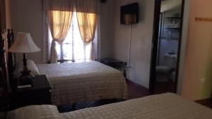 Łóżko lub łóżka w pokoju w obiekcie Hotel Acropolis Maya
