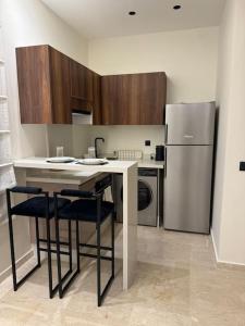 a kitchen with a refrigerator and a table and chairs at 48 Luxury Adam -Corniche à 5 min - smart TV in Casablanca