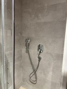 a shower with a hose in a shower stall at 48 Luxury Adam -Corniche à 5 min - smart TV in Casablanca +13 photos