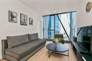 a living room with a couch and a table at Luxury apartment in Melbourne in Melbourne