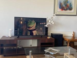 a living room with a tv with a frog on the screen at Departamento en Condominio Puerto Pacífico in Viña del Mar +28 photos
