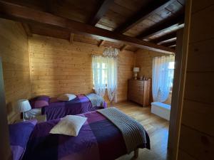 a bedroom with two beds in a log cabin at Le Sorgenti Casa Vacanze in Altipiani di Arcinazzo +53 photos