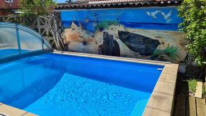a swimming pool with a painting of a boat at Ferienwohnung Heyne in Weinböhla