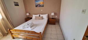 a bedroom with a bed with towels on it at Studios Anagnostou in Skala Marion