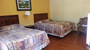 Postel nebo postele na pokoji v ubytování Hotel Brisas de Copan