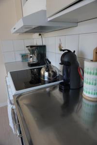 a kitchen counter with a sink and a stove at Friluftens våning in Hästveda