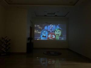 a room with a large screen with characters on it at Urban Zen Oasis - Independent floor in City Centre in Gwalior +9 photos