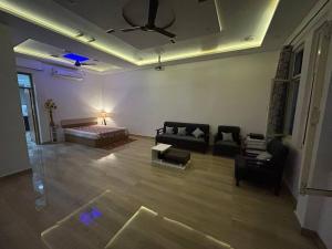 a living room with a bed and a couch at Urban Zen Oasis - Independent floor in City Centre in Gwalior