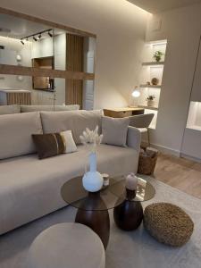 a living room with a white couch and a table at Cozy design 1 bedroom apartment in Bansko +40 photos