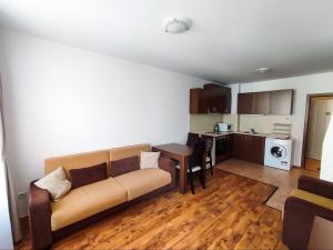 a living room with a couch and a kitchen at "Mountain Dream" Apartments 200m from Ski Road in Bansko +24 photos