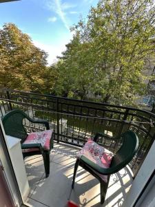 two chairs sitting on a balcony with a railing at Adel's in Subotica