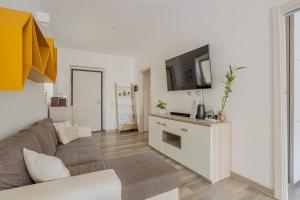 a living room with a couch and a tv at Marina Centro città in pieno centro storico in Cagliari