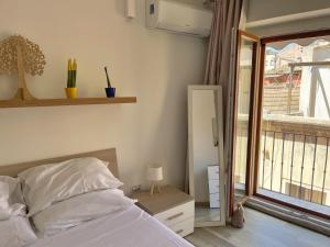 a bedroom with a bed and a window at Marina Centro città in pieno centro storico in Cagliari +20 photos
