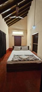 a large bed in a large room with a ceiling at Taramrata Homestay in Gokarna