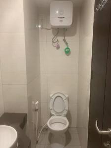a small bathroom with a toilet and a sink at Comfortstay - Citra Plaza Nagoya #31-08 Sea View in Jodoh +4 photos