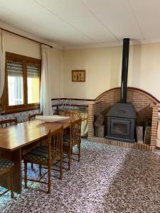 a dining room with a table and a wood stove at turismo rural la solana in Murcia