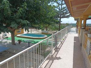 a balcony with a fence and a swimming pool at turismo rural la solana in Murcia