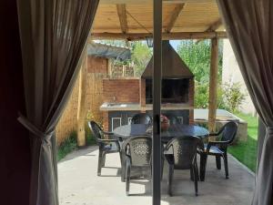 a patio with a table and chairs and a fireplace at Oasis Jadranca in Mendoza