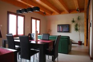 a dining room with a table and a green couch at la grange in Wintzenheim