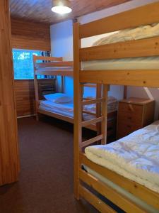 a bedroom with two bunk beds and a bed at T3 aux Ecrins IV, skis aux pieds à Vars in Vars +1 photo