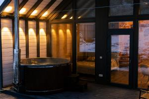 a large bath tub sitting inside of a house at Цекіт in Yaremche