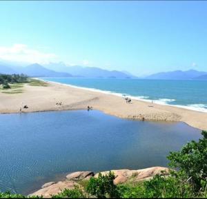 a beach with a large pool of water at 11Suites casa Suite #7 in Caraguatatuba
