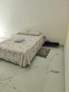 a bedroom with a bed in a white room at 11Suites casa Suite #7 in Caraguatatuba +7 photos