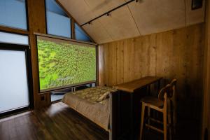 a small room with a table and a large window at Цекіт in Yaremche
