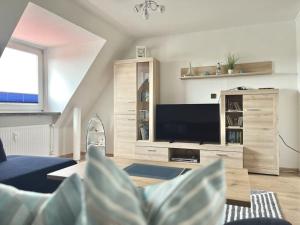 a living room with a couch and a tv at Wolke 7 von OstseeAhoi in Lübeck +12 photos