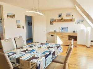 a bedroom with a bed and a table and chairs at Wolke 7 von OstseeAhoi in Lübeck