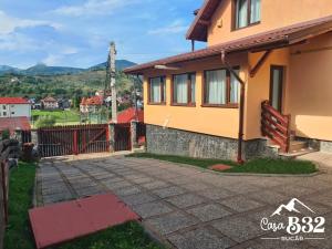 a house with a driveway in front of it at Casa B32 Spa Rucar in Rucăr