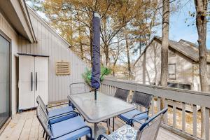 a table and chairs on a deck with a umbrella at Sea Colony --- 2305 Round Robin Way in Bethany Beach