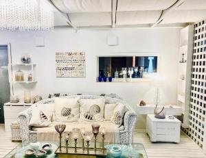 a living room with a white couch and a table at La Terrazza in Senigallia