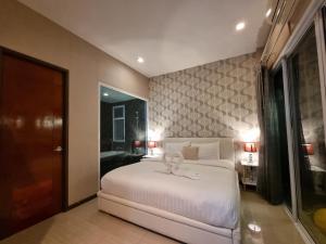 a bedroom with a bed with a butterfly on it at ChinJu PoolVilla in Jomtien Beach