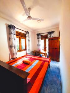 a bedroom with a large bed with a colorful blanket at Rasana Breezt Villa in Matara