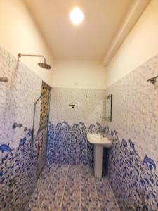 a bathroom with a sink and blue and white tiles at Rasana Breezt Villa in Matara +2 photos