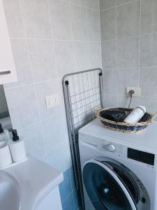 a washing machine with a basket on top of it at Casa del ruscello in Mezzana +20 photos