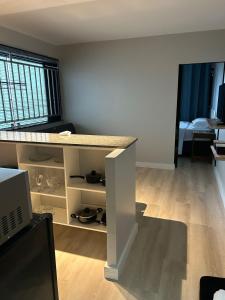 a room with a counter and a room with a bed at Kit 102 Brasília in Brasilia