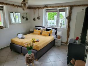 a bedroom with a large bed in a room with windows at U Miśków in Pobierowo