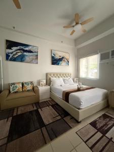 a bedroom with a bed and a ceiling fan at JK Suites Cheer B126 in Marilao