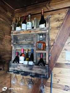a bunch of bottles of wine on a wall at Refugio Alpina lodge in El Canelo