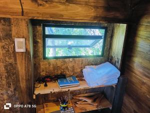 a desk in a room with a window at Refugio Alpina lodge in El Canelo